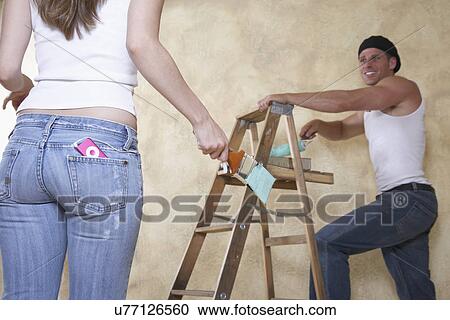 Stock Image - Couple painting room. Fotosearch