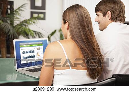 Couple using laptop, electronic banking View Large Photo Image Stock Photo - Couple using laptop, electronic banking. Fotosearch