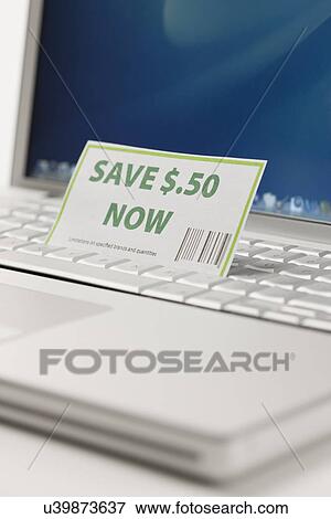 Coupon and laptop, close-up View Large Photo Image Stock Photo - Coupon and laptop, close-up. Fotosearch