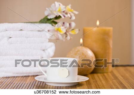 Cup of relaxing tea with towels and candles View Large Photo Image Stock Image - Cup of relaxing tea with towels and candles. Fotosearch