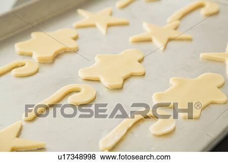 Stock Photo - Cutout cookies on baking sheet. Fotosearch