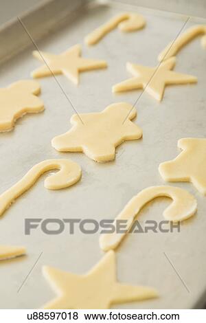 Stock Photo - Cutout cookies on baking sheet. Fotosearch