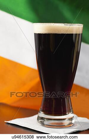 Stock Photo - Dark beer against Irish flag. Fotosearch