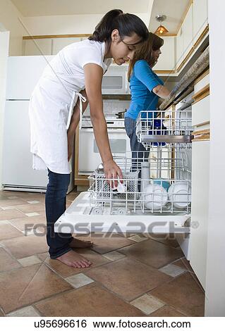 Daughter (14-15) helping mother in kitchen View Large Photo Image Stock Photograph - Daughter (14-15) helping mother in kitchen. Fotosearch