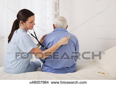 Doctor examining a senior patient View Large Photo Image Picture - Doctor examining a senior patient. Fotosearch