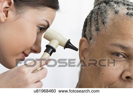 Doctor examining patients ear View Large Photo Image Stock Image - Doctor examining patients ear. Fotosearch