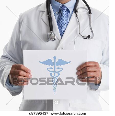 Stock Photo - Doctor holding paper with graphic of Caduceus symbol. Fotosearch