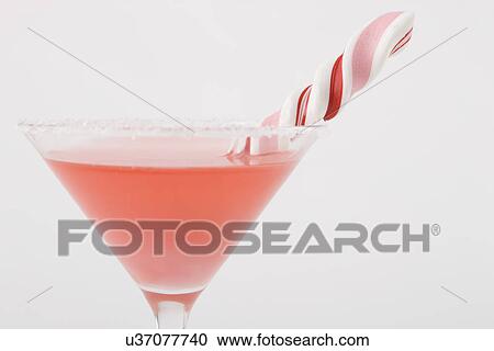 Stock Image - Drink with candy cane. Fotosearch