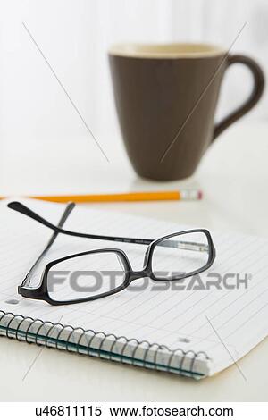 Eyeglasses on spiral notebook View Large Photo Image Stock Photography - Eyeglasses on spiral notebook. Fotosearch