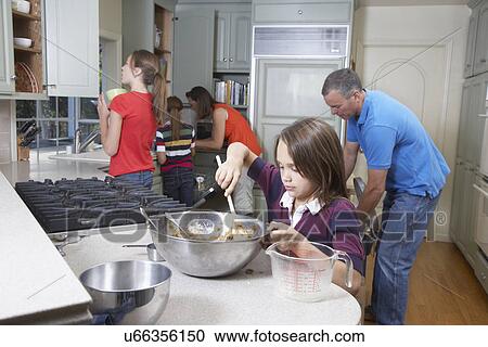 Family baking in kitchen View Large Photo Image Stock Image - Family baking in kitchen. Fotosearch