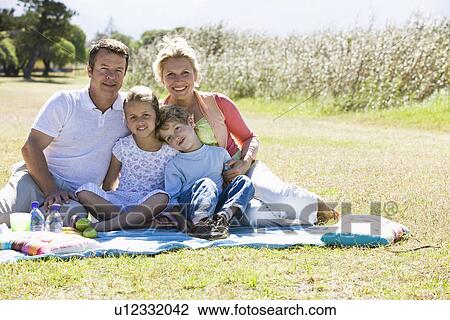 Family having picnic in park View Large Photo Image Stock Image - Family having picnic in park. Fotosearch