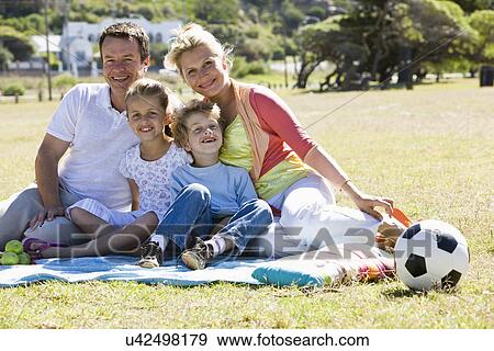 Family having picnic in park View Large Photo Image Stock Photo - Family having picnic in park. Fotosearch