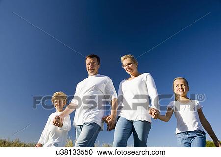 Family including boy and girl (8-9) against clear blue sky View Large Photo Image Stock Image - Family including boy and girl (8-9) against clear blue sky. Fotosearch
