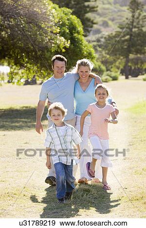 Family including boy and girl (8-9) walking in park View Large Photo Image Stock Photo - Family including boy and girl (8-9) walking in park. Fotosearch