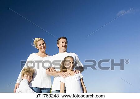 Family including boy and girl (8-9) against clear blue sky View Large Photo Image Stock Photo - Family including boy and girl (8-9) against clear blue sky. Fotosearch