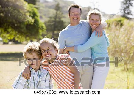 Family including boy and girl (8-9) walking in park View Large Photo Image Stock Photography - Family including boy and girl (8-9) walking in park. Fotosearch