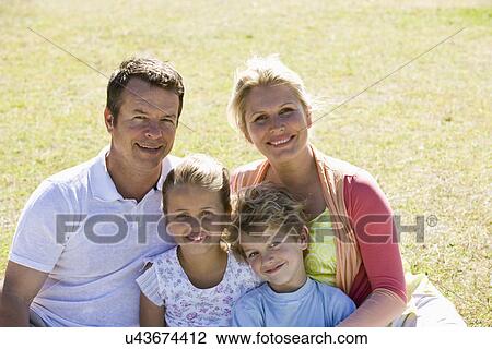 Family sitting in park View Large Photo Image Stock Image - Family sitting in park. Fotosearch