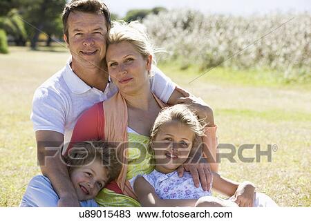 Family sitting in park View Large Photo Image Stock Image - Family sitting in park. Fotosearch