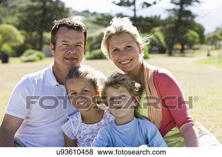 Family sitting in park View Large Photo Image Stock Photo - Family sitting in park. Fotosearch