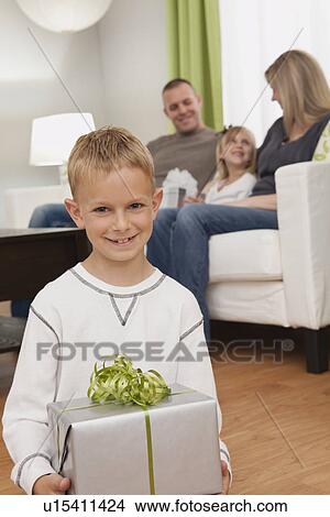 Picture - Family with boy and girl (6-7, 8-9) celebrating birthday. Fotosearch