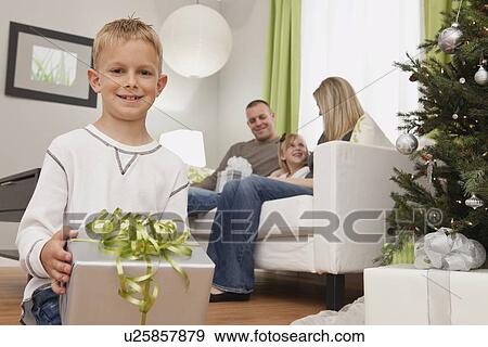 Family with boy and girl (6-7, 8-9) celebrating christmas View Large Photo Image Stock Photo - Family with boy and girl (6-7, 8-9) celebrating christmas. Fotosearch