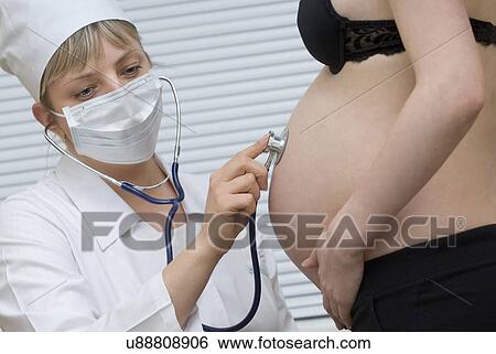 Female doctor examining pregnant woman View Large Photo Image Stock Photograph - Female doctor examining pregnant woman. Fotosearch