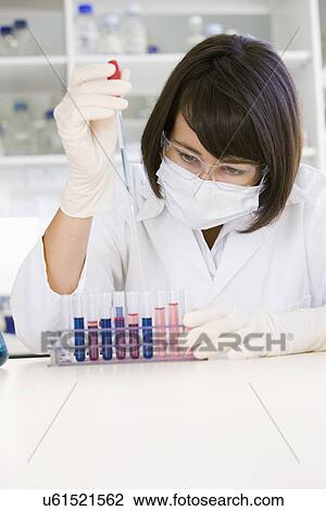 Stock Image - Female scientist doing research in laboratory. Fotosearch