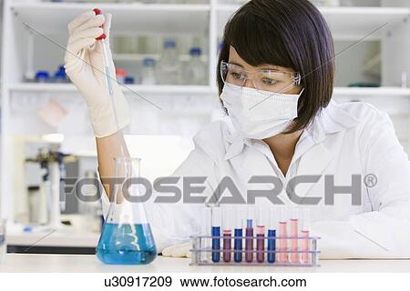 Stock Photo - Female scientist doing research in laboratory. Fotosearch