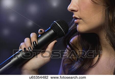 Female singer on stage View Large Photo Image Stock Image - Female singer on stage. Fotosearch