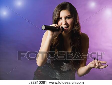 Stock Image - Female singer on stage. Fotosearch
