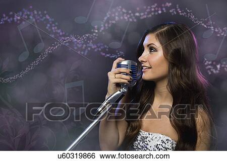 Stock Photograph - Female singer on stage. Fotosearch