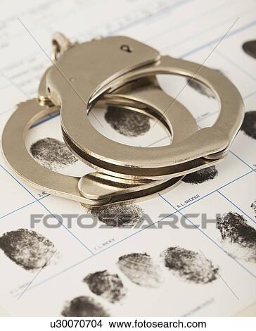 Picture - Fingerprints chart and handcuffs. Fotosearch