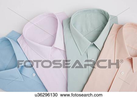 Folded shirts, studio shot View Large Photo Image Stock Image - Folded shirts, studio shot. Fotosearch