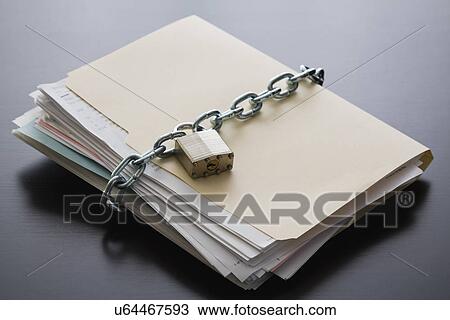 Stock Image - Folder with files closed with chain and padlock. Fotosearch