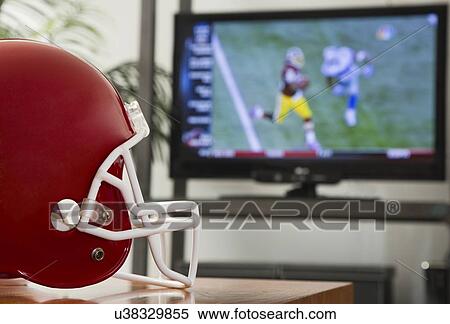 Football helmet in front of tv View Large Photo Image Stock Photography - Football helmet in front of tv. Fotosearch
