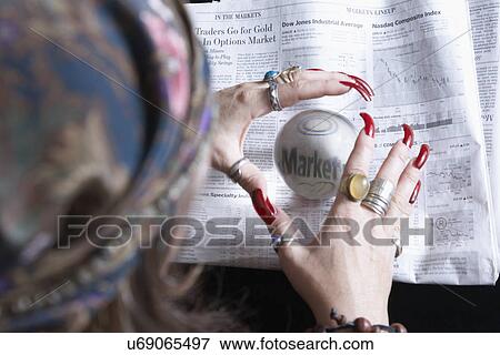 Fortune teller looking at newspaper financial pages through crystal ball View Large Photo Image Stock Photo - Fortune teller looking at newspaper financial pages through crystal ball. Fotosearch