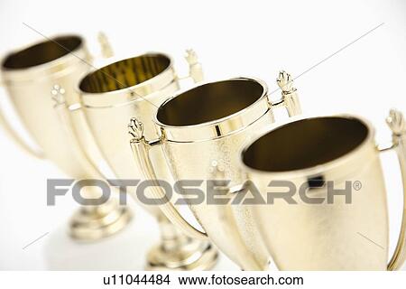 Picture - Four gold trophies in a row. Fotosearch