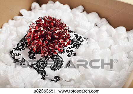 Gift packed in wrapping paper ready to send, studio shot View Large Photo Image Stock Image - Gift packed in wrapping paper ready to send, studio shot. Fotosearch