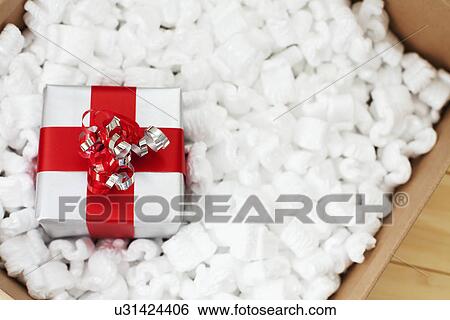 Gift packed in wrapping paper ready to send, studio shot View Large Photo Image Stock Photograph - Gift packed in wrapping paper ready to send, studio shot. Fotosearch