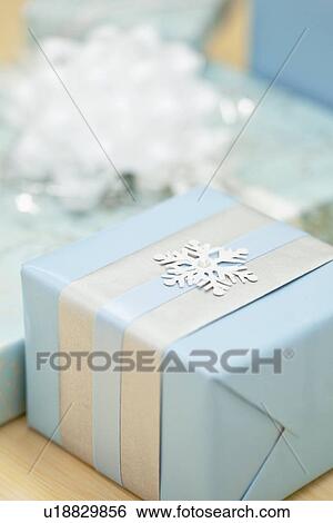 Stock Photograph - Gift with snowflake decoration, studio shot. Fotosearch