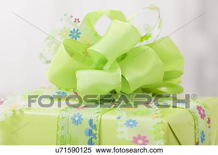Stock Photography - Gift wrapped in green paper. Fotosearch