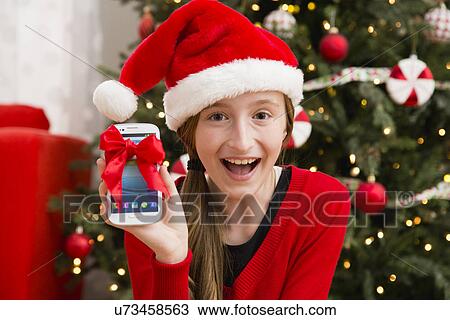 Girl (10-11) enjoying her Christmas present View Large Photo Image Stock Image - Girl (10-11) enjoying her Christmas present. Fotosearch
