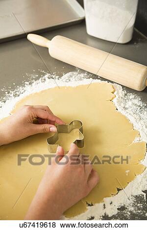 Girl (12-13) cutting cookie View Large Photo Image Stock Photo - Girl (12-13) cutting cookie. Fotosearch