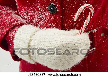 Girl (12-13) holding candy cane View Large Photo Image Stock Photo - Girl (12-13) holding candy cane. Fotosearch