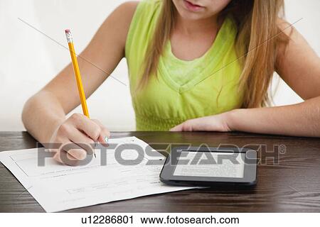 Girl doing homework using tablet pc View Large Photo Image Stock Image - Girl doing homework using tablet pc. Fotosearch