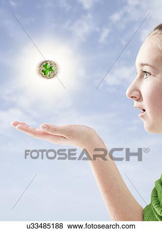 Girl with magic clover View Large Photo Image Stock Photo - Girl with magic clover. Fotosearch