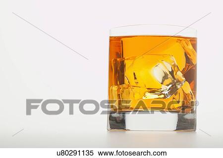 Glass of whiskey with ice cubes View Large Photo Image Stock Photography - Glass of whiskey with ice cubes. Fotosearch