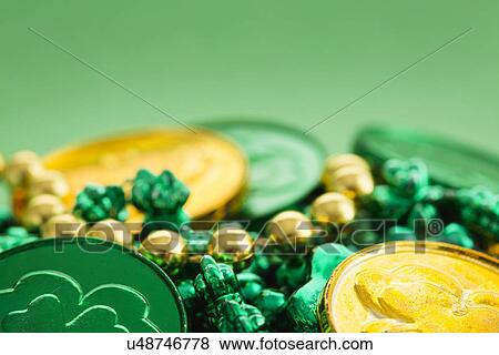 Gold and green coins and shamrock on green View Large Photo Image Stock Photo - Gold and green coins and shamrock on green. Fotosearch