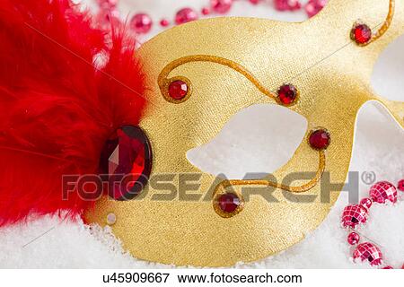 Gold and red mask on snow View Large Photo Image Stock Photo - Gold and red mask on snow. Fotosearch