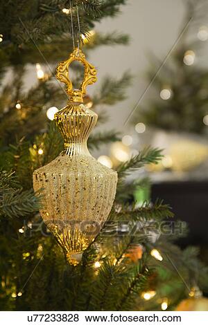 Gold ornament on Christmas tree View Large Photo Image Stock Photo - Gold ornament on Christmas tree. Fotosearch